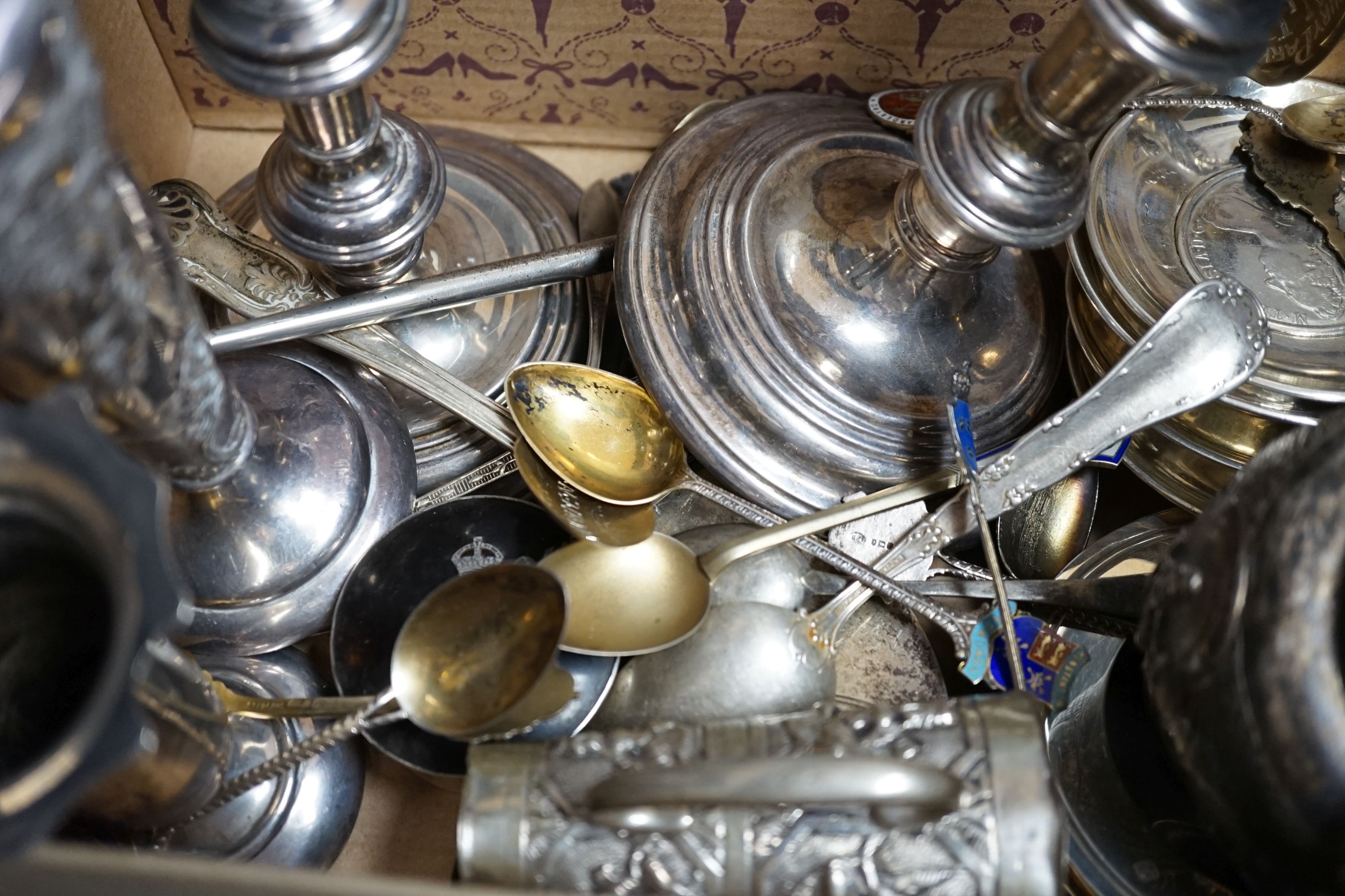 A pair of 1960's silver candlesticks, 19.2cm, weighted, a small silver vase, small silver and tortoiseshell pill box, two small silver armada dishes, two Indian white metal cream jugs, four 'coin' dishes, a quantity of a